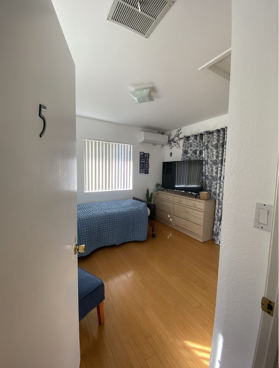 Private resident bedroom with dresser and television at Estar Board and Care in Northridge