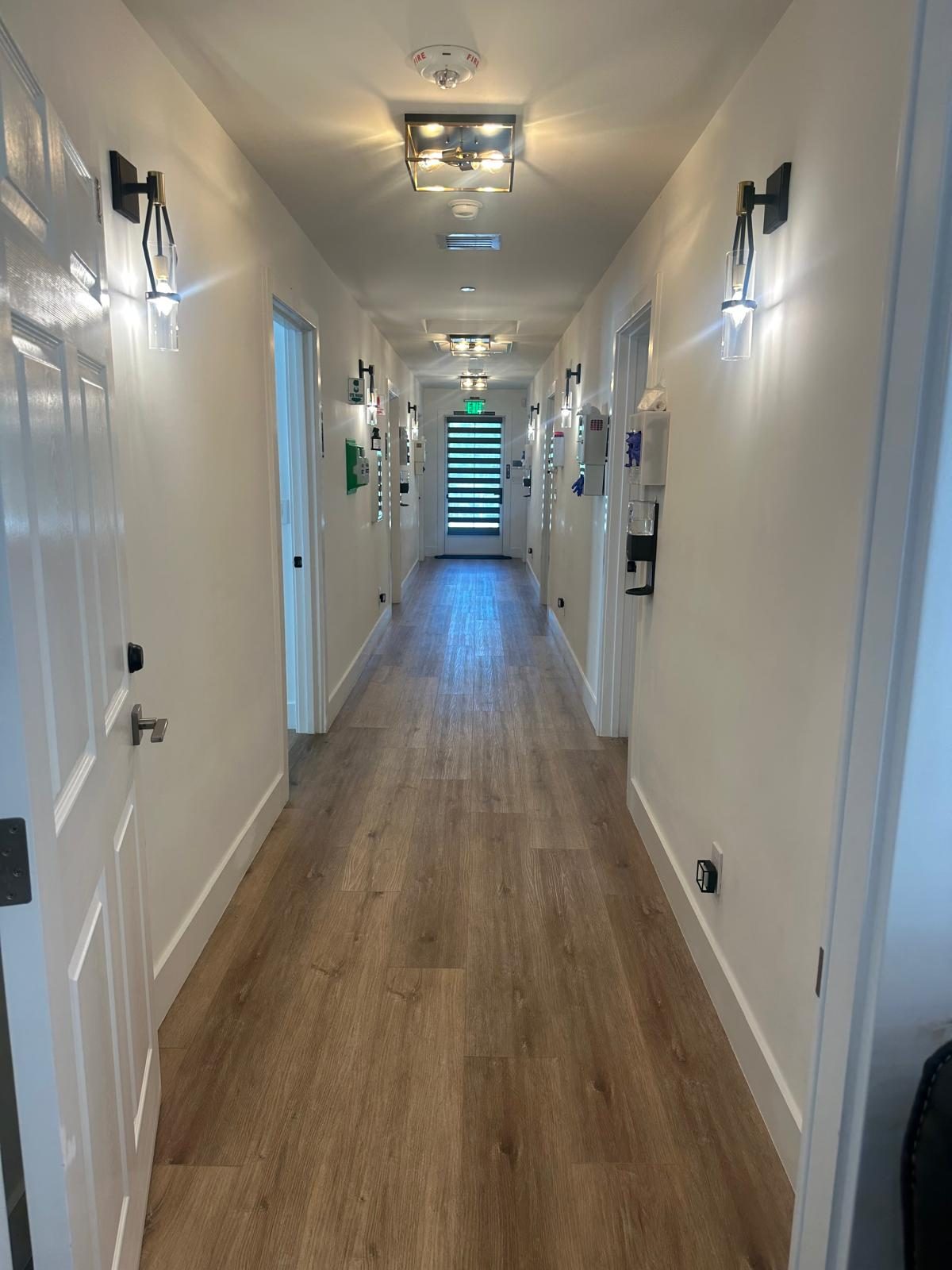 Hallway with resident room doors at Monogram Villa in Sherman Oaks